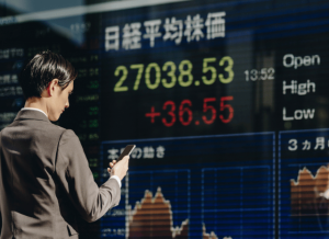 Stanislav_Kondrashov_Telf_ag_stock_market_display_with_businessperson.